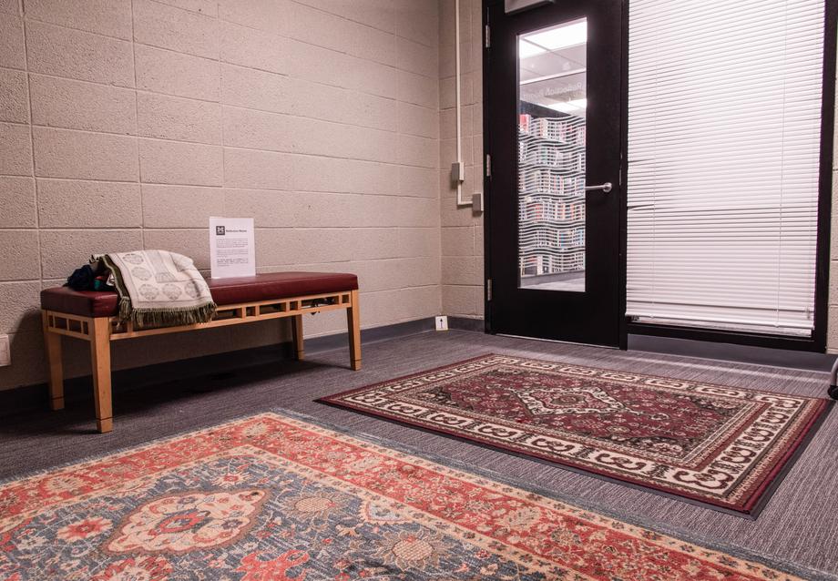 interior view of the shapiro reflection room with rugs and a bench