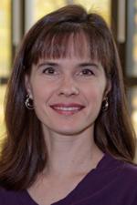 Doreen R Bradley&#039;s Photo.  A woman with dark brown hair and bangs, smiling and wearing a purple shirt.