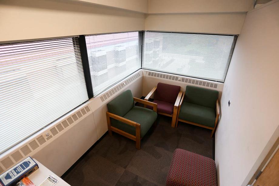 Aerial view of the Hatcher Library Reflection Room with three chairs and windows all around the perimeter.