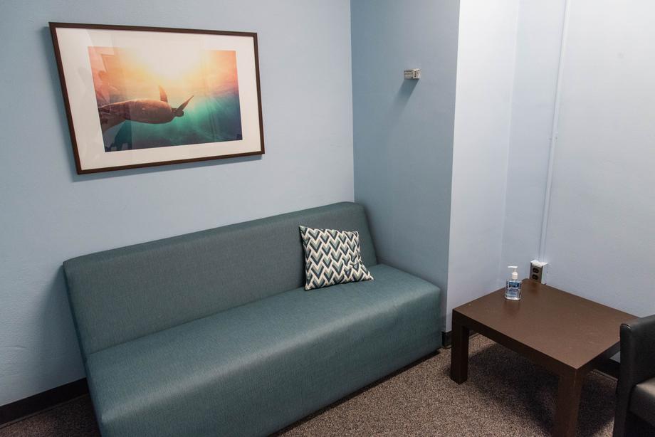 Couch and side table inside the Hatcher First Floor Lactation Room. 