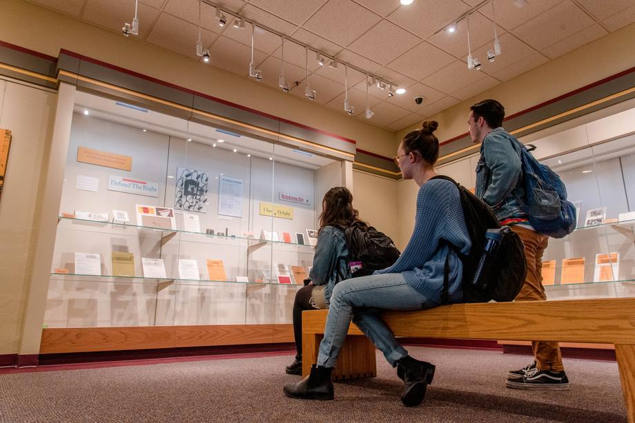 Students looking at an exhibit in the cases in the Audubon Room.