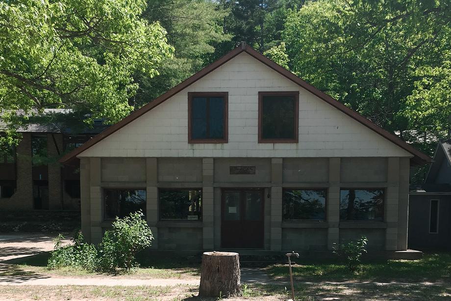 Exterior of the Biological Station building, surrounded by trees.